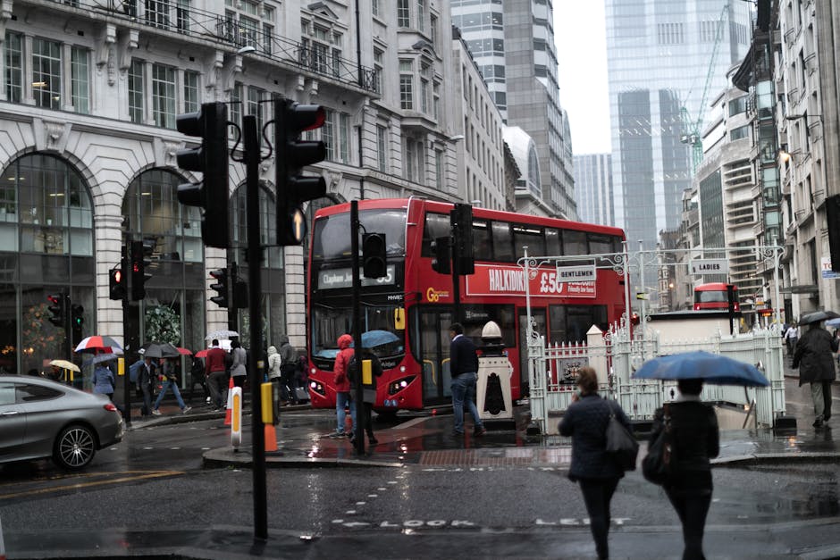 Rainy London street red double decker buses